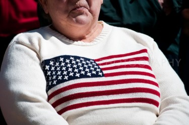 A woman with an American Flag sweater in the crowd at the New Hampshire Tea Party Coalition's "Tax Day' Rally at the State House in Concord, NH.