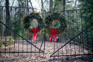 Wreaths on a gate to a creepy old house