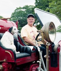 Fireman and dog in antique truck