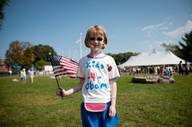 Rilley Brooks, 8, of Hanover wearing one of the many shirts she designed, made and donated proceeds to the campaign to re-elect Barack Obama at a rally for the president held at Strawberry Banke in Portsmouth on Friday.