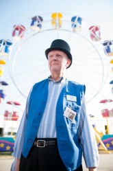 Rochester Fair Ambassador & Voice Joel Sherburne stands opens the Rochester Fair in style with a top hat in front of a Ferris wheel at the Rochester Fairgrounds on Friday.