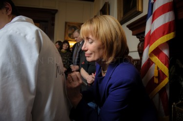 New Hampshire governor Maggie Hassan autographs a shirt during a receiving line  at the statehouse in Concord on January 3rd.